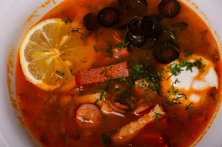 Traditional Ukrainian borsch with sour cream and white beans on a dark background. Red vegetable beetroot soupの写真素材