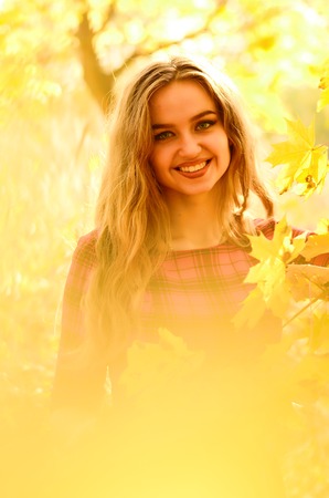Outdoor fashion photo of young beautiful lady surrounded autumn leavesの写真素材