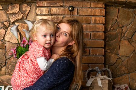 Family at Christmas with the boy. New Year photo session in the studio. Dad and his mom on holidays communicate with his son in the living room. Lutsk, Ukraine 28.12.18のeditorial素材