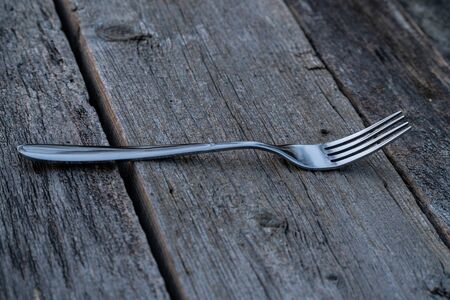 knife and fork on wooden background. Cutlery on woodenの写真素材