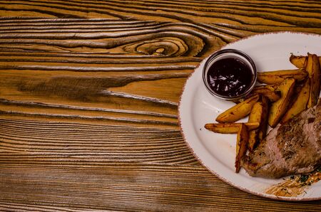 Meat balls with potatoes in a baking dish and sour cream close-up on a table. horizontal view from above.の写真素材