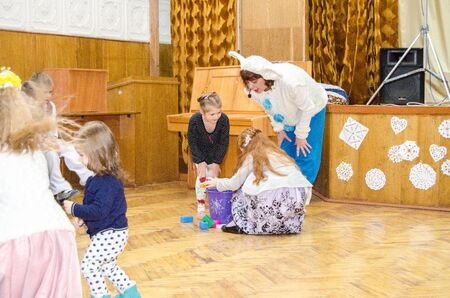 Children's Christmas New Year's concert. Children play with Snow Maiden and Santa Claus. Emotional bright children's show in elementary school. 24 school Ukraine Lutsk 19-06-2016.のeditorial素材