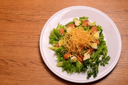 Ethical vegetarian or vegan meal. Boiled quail eggs in a spiralized fried potato french fries nest, Served with baby leaf salad. Healthy low calorie slimmer's meal made with a spiralizerの写真素材