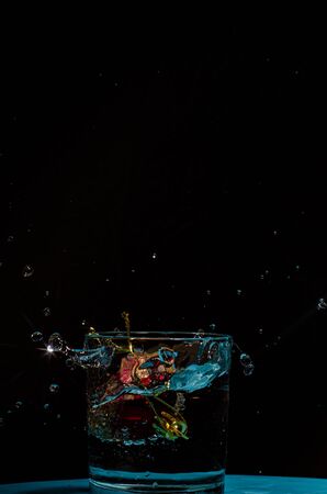water splash in glass isolated on black background