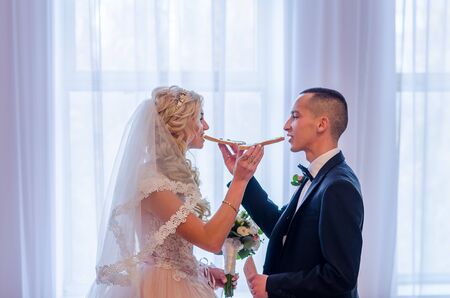 Bride and Groom at wedding Day walking Outdoors on spring nature. Bridal couple, Happy Newlywed woman and man embracing in green park. Loving wedding couple outdoor. 12.03.18 lutsk, Ukraine.のeditorial素材