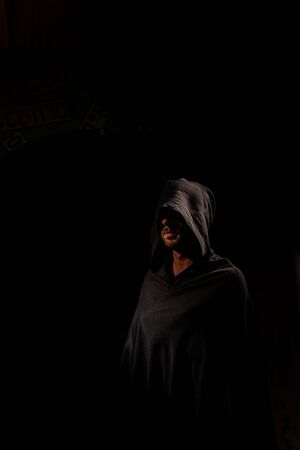 Portrait of a courageous warrior wanderer in a black cloak. Historical fantasy. Halloween.の写真素材