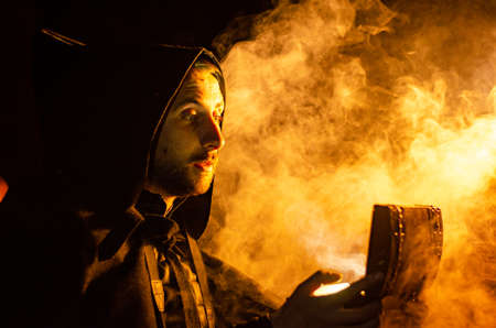 Portrait of a courageous warrior wanderer in a black cloak. Historical fantasy. Halloween.の写真素材