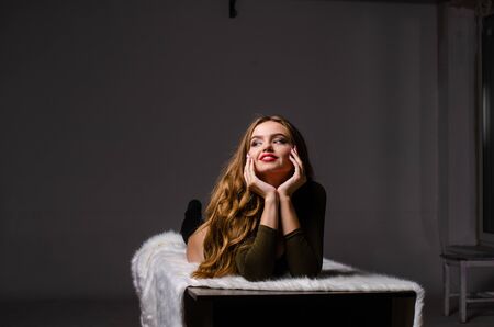 Beautiful dancer. Girl model. the girl sits in a hat and sits on a table. girl in a beautiful...