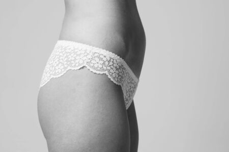 portrait of exquisite woman in lingerie sittingの写真素材