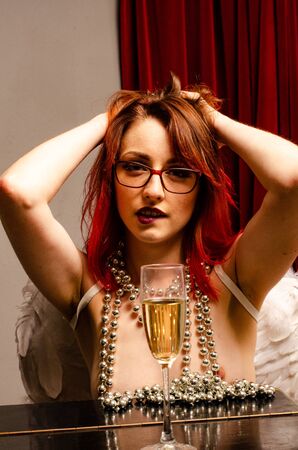Naked girl in the image of an angel with Red Hair.