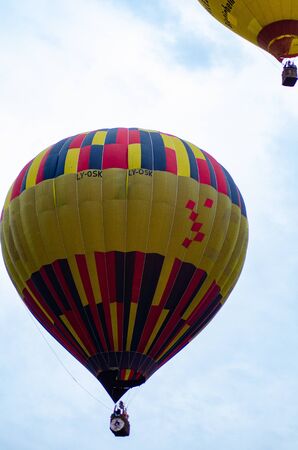 hot air balloon is flying at sunrise.の写真素材
