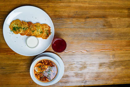 Pieces of chop (schnitzel), toast with eggs, fresh tomato on a wooden board on a dark background....