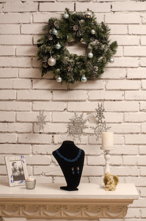 Beaded necklace with turquoise earrings on black velvet bust isolated on white background. Female accessories, decorative ornaments and jewelry. Fashion and style concept.の写真素材