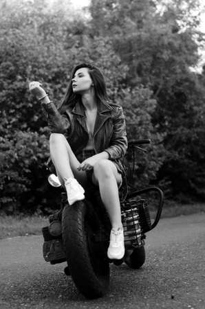 Black and white photo from a beautiful roughneck young woman with a hat and sunglasses. Color...