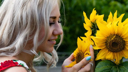 Pretty young blonde woman in the parkの写真素材