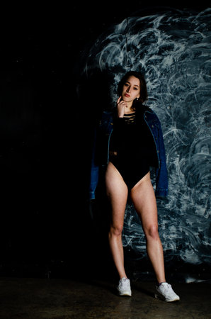 sexy girl in a red bodysuit and denim jacketの写真素材