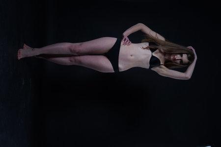 beautiful sexy brunette in lingerie in the studio on a black backgroundの写真素材