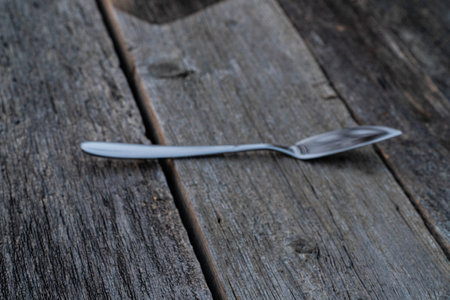 Empty spoon on a wooden table. Selective focus. Copy space.の写真素材