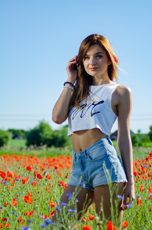 pretty woman in the field of poppies.の写真素材