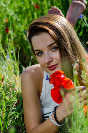 pretty woman in the field of poppies.の写真素材