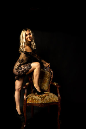 Sunning sexy beautiful young woman blond long hair and of short elegant dress.の写真素材