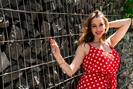 girl in a red dress in white polka dotsの写真素材