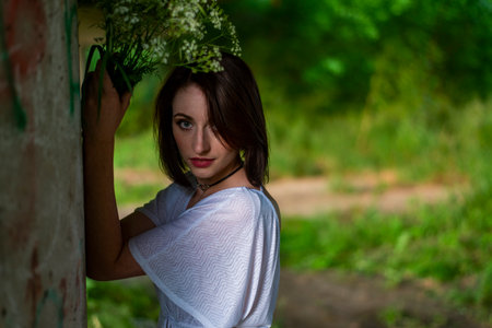 Portrait of a beautiful young woman with a bouquet of flowers.の写真素材