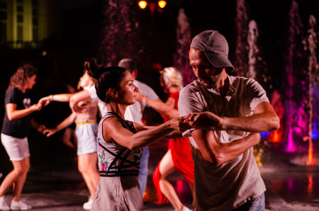 Lutsk, Ukraine - August 4, 2018. People dancing salsa and bachata in outdoor cafe by Diana in Lutsk.のeditorial素材