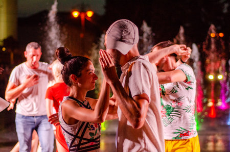 Lutsk, Ukraine - August 4, 2018. People dancing salsa and bachata in outdoor cafe by Diana in Lutsk.のeditorial素材