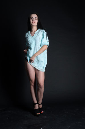 Full length portrait of a beautiful young brunette woman posing in studioの写真素材