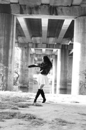 Close-up portrait of a fantastic young model girl posing in the park on a sunny day. Black and white photoの写真素材