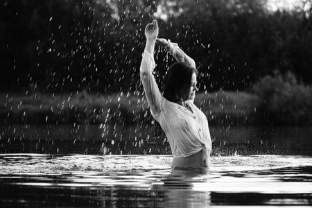 Beautiful young woman in the water. Black and white photo.の写真素材
