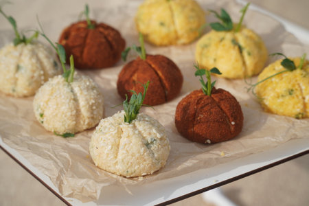 Fried cheese balls with parsley on the table in the restaurantの写真素材
