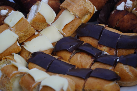 Close up of a variety of eclairs with chocolate and creamの写真素材