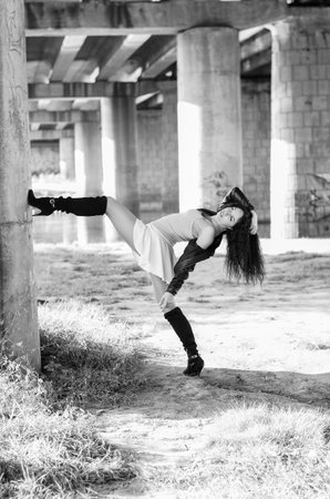 Close-up portrait of a young model girl posing in the park on a sunny day. Black and white photo.の写真素材