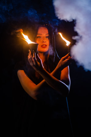 Young girl in a long black coat.の写真素材