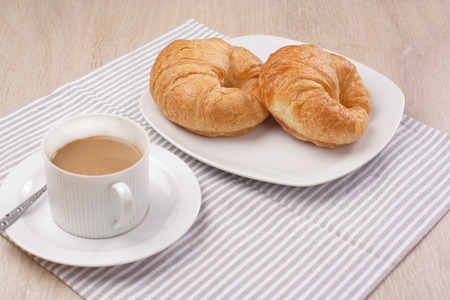 Breakfast croissant and coffee on woodenの写真素材