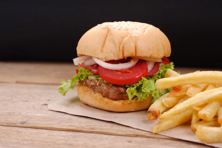 hamburger and french fries on wooden backgroundの写真素材