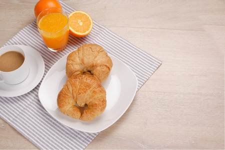 Breakfast coffee and orange juice on woodenの写真素材
