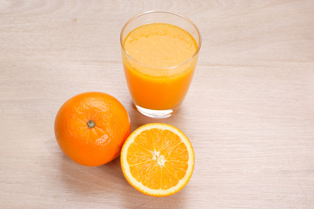 Orange juice with Oranges on wooden backgroundの写真素材