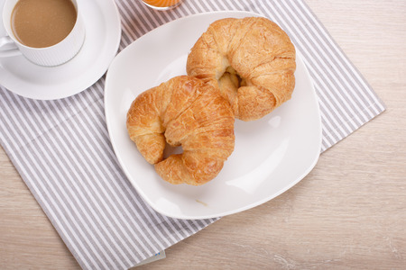 Breakfast croissant and coffee on woodenの写真素材