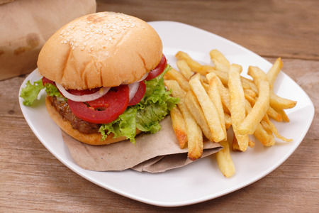 hamburger and french fries on wooden backgroundの写真素材