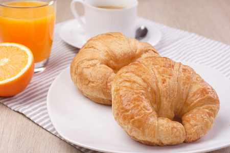 Breakfast coffee and orange juice on woodenの写真素材