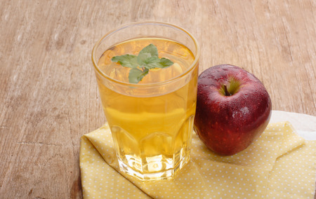 Apple juice and apples on wooden table. Selective focusの写真素材