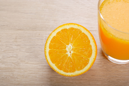 Orange juice with Oranges on wooden backgroundの写真素材
