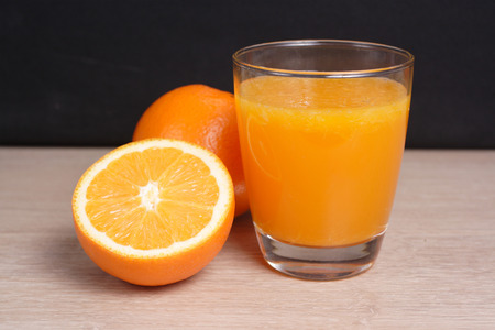 Orange juice with Oranges on wooden backgroundの写真素材