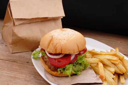hamburger and french fries on wooden backgroundの写真素材