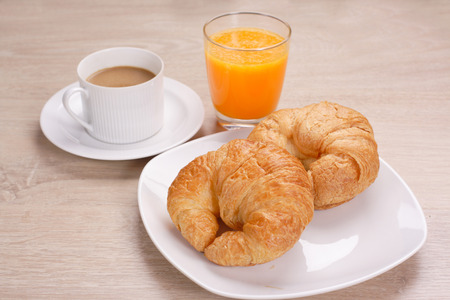 Breakfast coffee and orange juice on woodenの写真素材