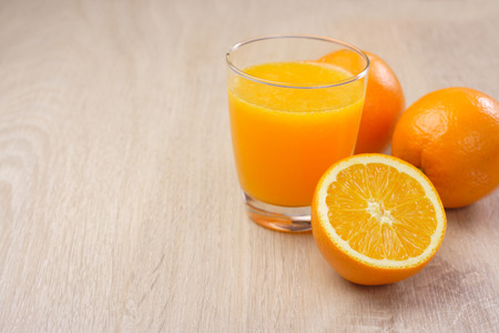 Orange juice with Oranges on wooden backgroundの写真素材