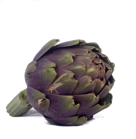 Fresh artichokes with leaves in heap on display on a white background.の写真素材